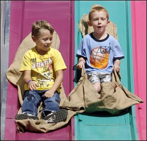 Joshua Emerling, left, and Calib Brashear, both of Defiance, ride the big slide at the 2010 Fulton County Fair in Wauseon, Ohio.