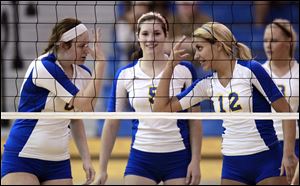 St. Ursula’s Cassidy Croci, left, Katie McKernan and Madison Strall, celebrate scoring a point. The Arrows finished with a 28-1 record last year.
