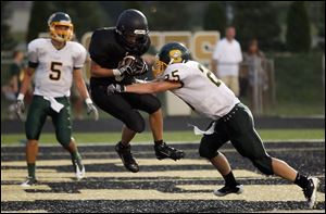 Perrysburg wide receiver Ian Wagner hauls in a touchdown pass against coverage by Clay's Kyle Steveson.