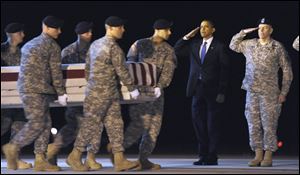 President Barack Obama salutes with Maj. Gen. Daniel Wright, right, as a carry team carries the transfer case containing the remains of Army Sgt. Dale R. Griffin of Terre Haute, Ind., who died in Afghanistan, during a dignified transfer at Dover Air Force Base in Dover, Del., on Oct. 29, 2009.