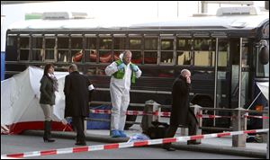 Police investigate the scene March 2 after a gunman fired shots at U.S. soldiers on the bus outside Frankfurt airport, Germany.