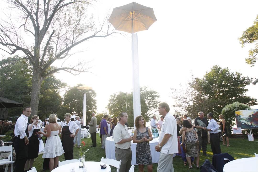 The-crowd-mingles-under-white-canopy-lights