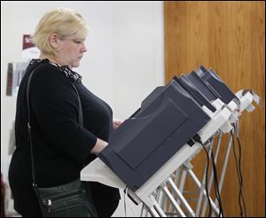 Michelle Portteus casts her ballot at Concordia Lutheran Church on South Detroit Avenue in Toledo. Voters also cast ballots across Michigan on Tuesday.