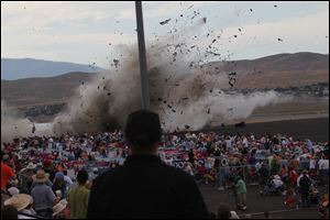 A P-51 Mustang airplane crashes into the edge of the grandstands at the Reno Air show on Friday. The World War II-era fighter plane flown by a veteran Hollywood stunt pilot Jimmy Leeward.