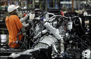 Line worker Randee Boose assembles a Chevrolet Silverado a pickup truck at the General Motors Flint Assembly plant in Flint, Mich.