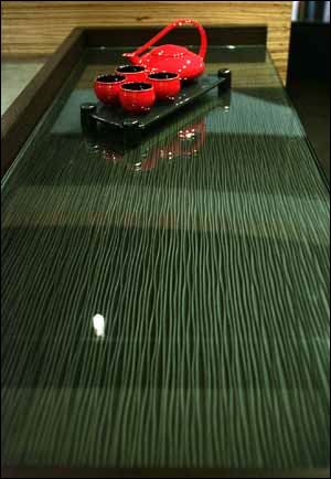A clear glass countertop is one alternative to granite in a modern kitchen.