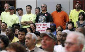 City union members listen as  city council delayed a vote on a fact-finding report for public employees Tuesday, 09/20/11, in Toledo, Ohio.