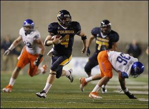 Toledo quarterback Austin Dantin picks up first down during the first quarter of game against Boise State at the Glass Bowl last Friday.