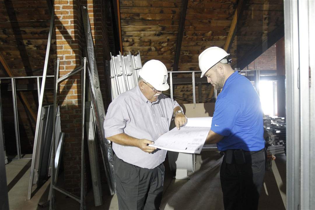 Joseph-Lenhart-left-and-Jason-Fleming-look-at-the-blueprints-in-the-Auglaize-County-courthouse
