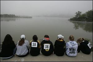 A team from Upper Arlington wait out the fog delay during the 2011 Frogtown Races Regatta at International Park in downtown Toledo.