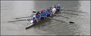 St. Ursula Academy rows to the starting position during the 2011 Frogtown Races Regatta at International Park in Toledo. A total of 47 teams on 323 boats competed in 32 events over a three-mile course on the Maumee River.