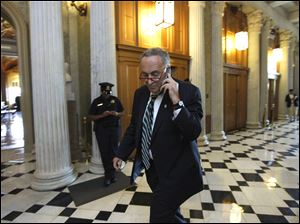 Sen. Charles Schumer, D-N.Y., a key member of the Senate Democratic leadership, walks on Capitol Hill in Washington, Monday, Sept. 26, 0211, as the Senate prepares to vote on a short-term funding measure that includes dollars for disaster relief without an offsetting spending cut elsewhere, as demanded by the GOP-controlled House.