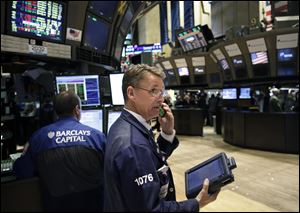 Traders work on the floor at the New York Stock Exchange in New York.