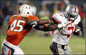 Ohio State running back Jordan Hall (7) runs as Miami linebacker Ramon Buchanan (45) defends during the second quarter of an NCAA college football game in Miami, Saturday, Sept. 17, 2011.