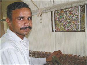 After his home was destroyed by flood waters, Mohammad Mushtag knots rugs in a short term facility built by Bunyaad, the fair trade artisan group.
The foundation also helps artisans rebuild their homes.