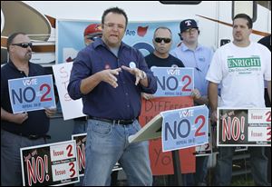Doug Stern, a Cincinnati firefighter, speaks against State Issue 2 during a We Are Ohio bus tour stop Wednesday in Toledo.