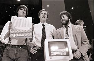 Steve Jobs, left, chairman of Apple Computers, John Sculley, center, then president and CEO, and Steve Wozniak, co-founder of Apple, unveil the new Apple IIc computer in San Francisco in 1984.