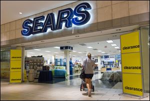 A customer pushes a stroller into the second floor entrance to a Sears store in a shopping mall in Columbus, Ohio, Tuesday, July 10, 2007. Sears is considering Columbus as a potential location for its HQ.