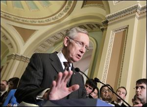 Senate Majority Leader Harry Reid of Nevada meets with reporters Tuesday on Capitol Hill in Washington after a Democratic caucus lunch. 