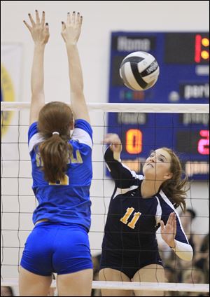 St. Ursula's Lauran Graves, 8, tries to block the shot of Madeline Smyth, who led the Eagles (8-8) with 11 kills.