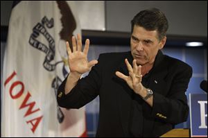 Republican presidential hopeful Texas Gov. Rick Perry speaks Friday during the Johnson County GOP Fall BBQ at Clear Creek-Amana High School in Tiffin, Iowa.