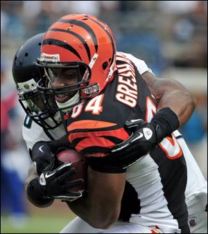 Cincinnati Bengals tight end Jermaine Gresham (84) is tackled by Jacksonville Jaguars free safety Dawan Landry (26) the fourth quarter of an NFL football game, Sunday.