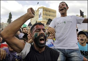 Anti-Syrian regime protesters shout slogans against Syrian President Bashar Assad, during a protest after Friday prayers in the northern city of Tripoli, Lebanon, on Friday Oct, 7, 2011 in a show of support for Syrians protesting against Syrian President Bashar Assad.