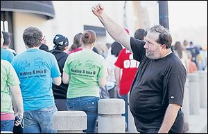 Jim O’Fahey cheers on the walkers who articipated in what is one of several large events downtown this month to aid the homeless. Among them is the annual Tent City, scheduled for Oct. 28-30.