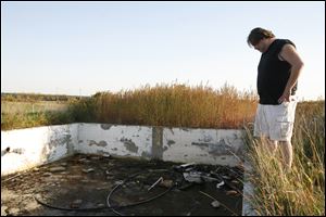 David Hunt looks at the corner of his family's rental house, which  was blown apart by the tornado that hit the area on the night of June 5, 2010. For more than a year, the family has been living in several locations.