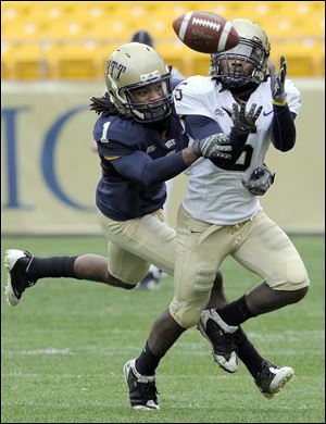 Toledo Technology Academy graduate Jeremiah Davis, left, looks to break up a pass intended for Cam Saddler during the University of Pittsburgh's annual intersquad Blue-Gold game at Heinz Field.