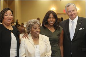 From left, Jennifer R. Bembry, of Mercy Medical Center, a presenting sponsor of the event, Patrice Johnson, and her granddaughter Thelma Huston, accepting the award for Johnson's late husband Richard Allen Huston, Sr., PhD., and Joseph H. Zerbey, IV, of the Blade, a presenter of the event.