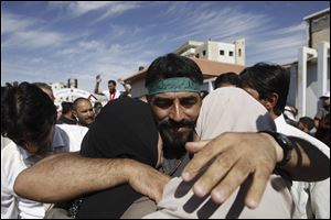 Palestinians celebrate the release of prisoners in the West Bank city of Ramallah, Tuesday, Oct. 18, 2011. The Hamas militant group released an Israeli soldier more than five years after his capture, turning him over to Egyptian mediators in exchange for hundreds of Palestinian prisoners.