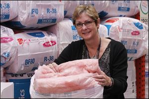 Gale Tedhams, director of sustainability-green products for Owens-Corning, touts the new touchable Ecotouch insulation product at the Home Depot in Toledo.