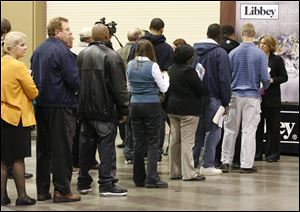 Job seekers line up to talk to Angie Zalesak, corporate human resources manager for Libbey Inc., right, during the Jobs & Career Fair 2011 at the SeaGate Convention Centre. She said she aimed to find candidates to fill 15 to 20 general labor jobs.