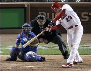 St. Louis Cardinals' David Freese hits a double off Texas Rangers' C.J. Wilson during the sixth inning of Game 1 of baseball's World Series Wednesday.