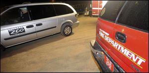 A vehicle from the Columbus Zoo and a vehicle from the Falls Township Fire Department sit parked in the staging area.