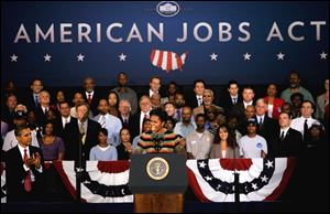 First lady Michelle Obama introduces her husband, President Barack Obama, while at a stop Wednesday at Joint Base Langley-Eustis in Hampton, Va. 