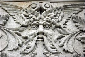 A face gazes down from the Adams Street side of the Lucas County Courthouse.