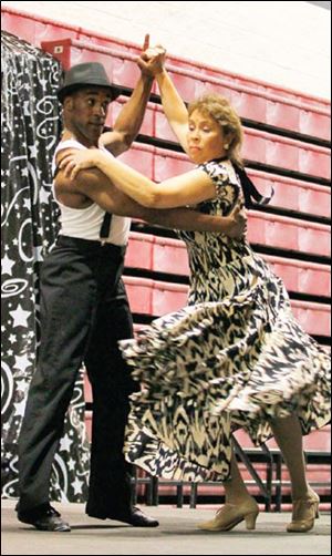 Dance instructor Paul Long and KeyBank vice president Diane Ohns dance a paso doble.