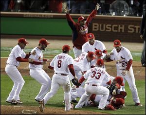 St. Louis Cardinals react after beating the Texas Rangers 6-2 at Game 7 of baseball's World Series Friday, in St. Louis. The Cardinals win the series 4-3.