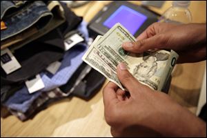 A customer pays for clothes at a Gap store in Palo Alto, Calif. 