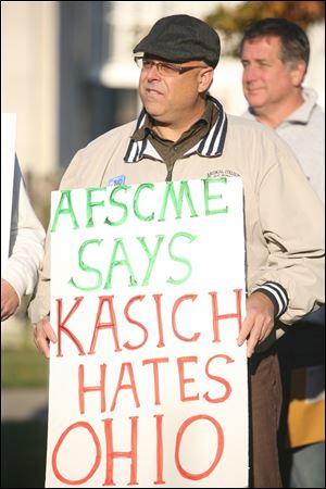 Randy Desposito holds a sign that reads 