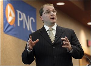 Kurt Rankin, an assistant vice president and economist for The PNC Financial Services Group, speaks to invited guests at the PNC Bank's annual luncheon at the Pinnacle in Maumee.