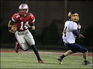 Central Catholic player DeShone Kizer, 14, turns around Olmsted Falls player Brandon Friedrich, 34, during the first quarter at Gallagher Stadium in their Division II high school football playoff game.