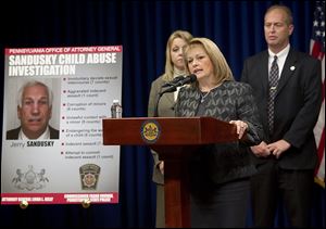 Pennsylvania Attorney General Linda Kelly, at podium, discusses the case against ex-Penn State defensive coordinator Jerry Sandusky. She said head coach Joe Paterno, a member of the College Football Hall of Fame, is being cooperative and is not seen as a target.