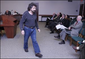 Kevin Haddad, a Sylvania Township trustee, leaves the lectern after asking a question about the proposed reform. Members of city council also asked questions.