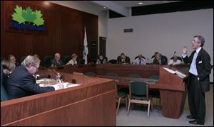 Thomas Palmer, a member of the volunteer panel campaigning to reorganize Lucas County into a home-rule government, addresses the Sylvania City Council meeting.