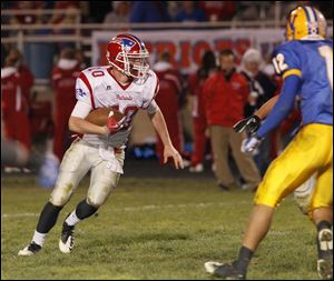 Patrick Henry quarterback Gabe Jones runs the ball during the Division V playoff opener against Northwood High School.