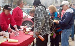 Kim Zavotski and Mike Janiszewski hand out food during Zavotski's Customer Appreciation Day