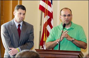 FILE - In this July 6, 2011 file photo, Chris Littleton, right, co-founder of the Ohio Liberty Council, and Maurice Thompson, director of 1851 Center for Constitutional Law, answer questions during a news conference in Columbus, Ohio. Just days after Ohio voters overwhelmingly rejected a state law curbing collective bargaining rights, Littleton announced the group will submit the proposed wording for its right-to-work amendment to the state's attorney general.
